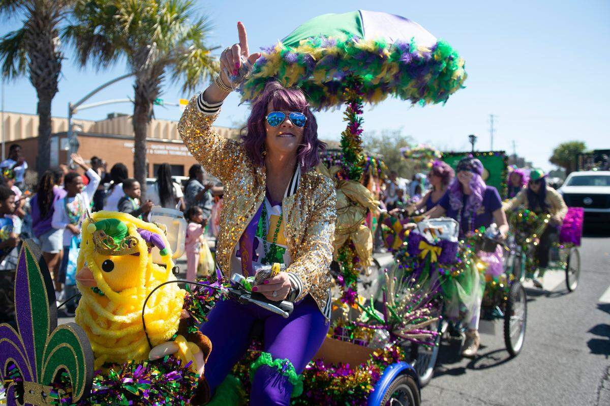 Krewes toss beads and other throws during the Jackson County Carnival Association Mardi Gras parade in Pascagoula on Saturday, March 1, 2025.