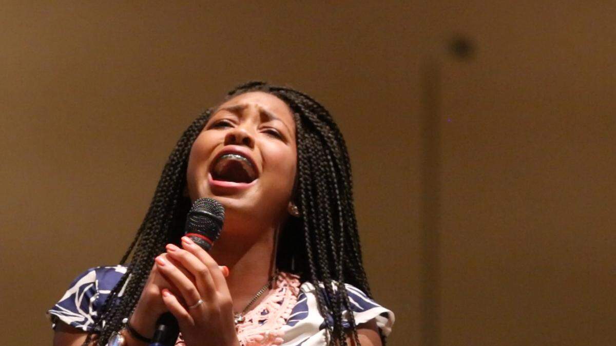JOHN FITZHUGH/SUN HERALD 
 Autumn Bolden-Smith, 14, sings at the National Crime Victims' Rights Week Candlelight Ceremony at First Baptist Church Gulfport on Friday April 15, 2016. Smith was a victim of sexual assault when she was 11, and now speaks out about recovering from being a victim.