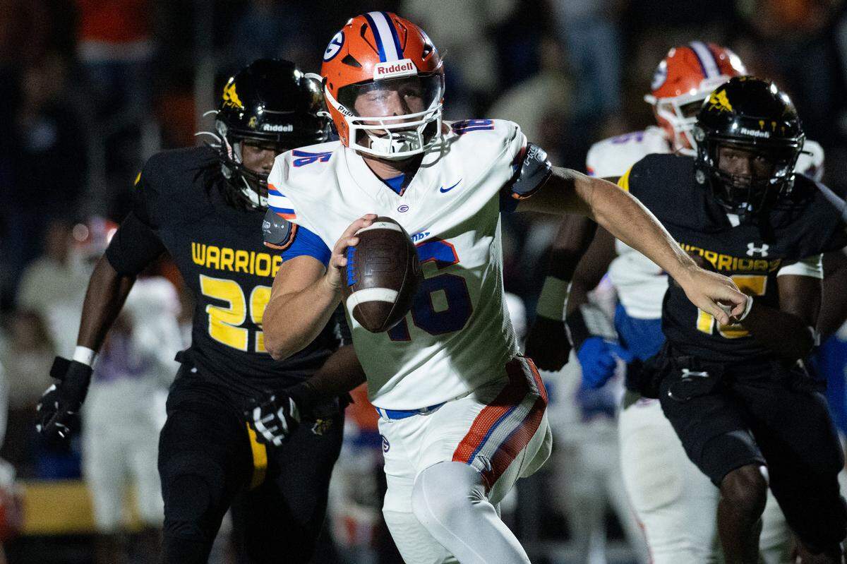 Gulfport quarterback Parker Nettles (16) scrambles as he looks downfield to pass during a football game at Warrior Stadium on Oct. 31, 2025.