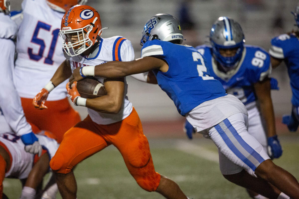 Ocean Springs’ Trace Carter tackles Gulfport’s Cooper Crosby during a game at Greyhound Stadium in Ocean Springs on Friday, Oct. 28, 2022.