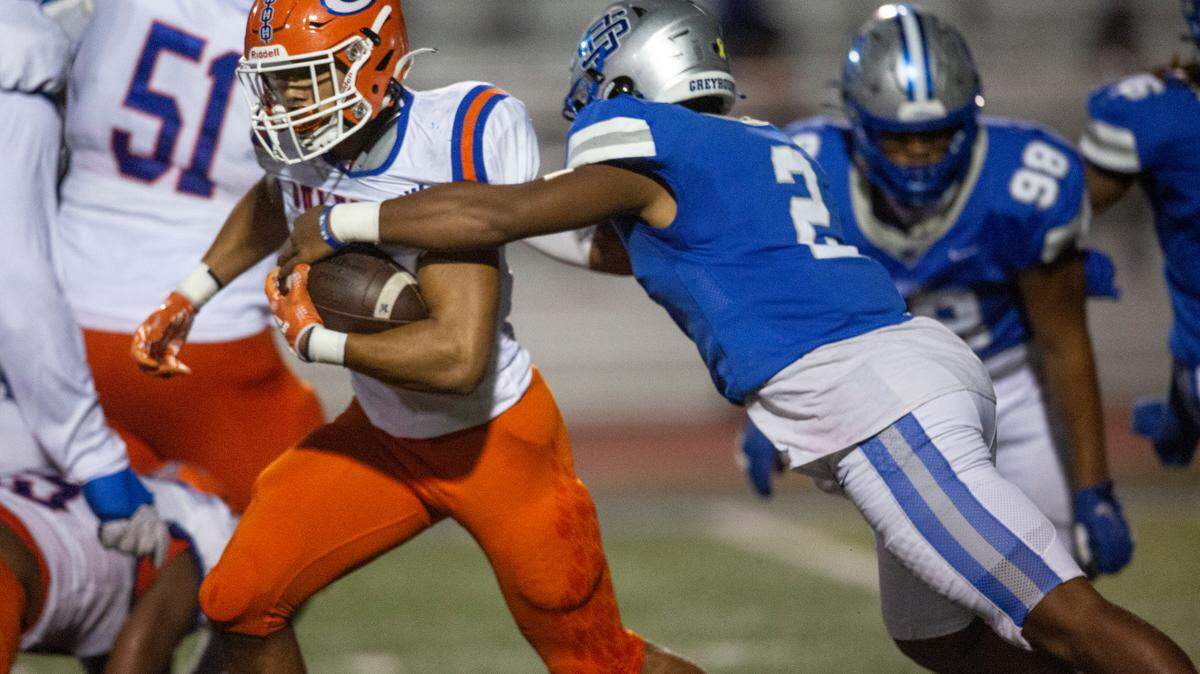 Ocean Springs’ Trace Carter tackles Gulfport’s Cooper Crosby during a game at Greyhound Stadium in Ocean Springs on Friday, Oct. 28, 2022.