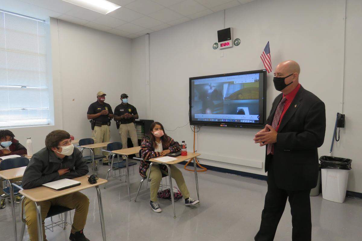 Students Brayden Beyers and Cecilliya Wesley listen to William Carey University crimnial justice instructor George Chaix speak to their class on Oct. 20, 2020. Moss Point Police Department officers Lamar Underwood and Kenny Dunn stand at the back of the room.