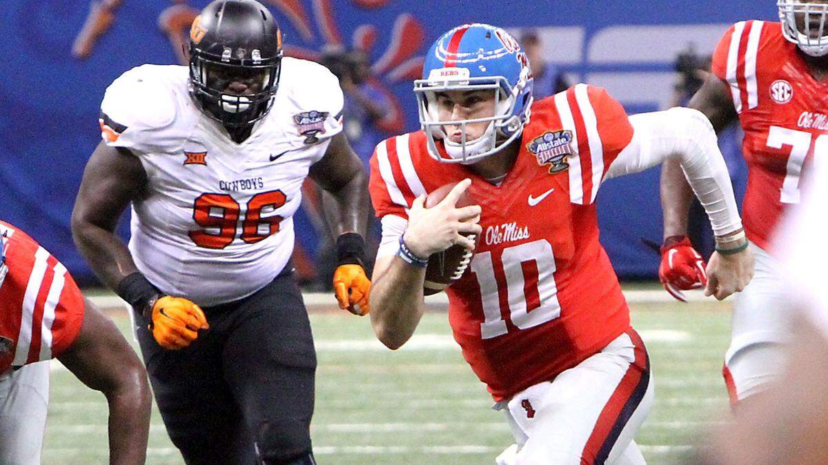 TIM ISBELL/SUN HERALD 
 Ole Miss quarterback Chad Kelly scrambles for a first down near the goal line to set up a final Rebel touchdown before halftime during the All State Sugar Bowl in New Orleans, Friday, Jan. 1, 2016.