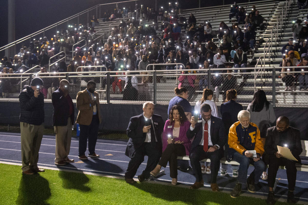 Family, friends and community members wave cellphones during a candlelight vigil in honor of three Gautier High School graduates at Gautier High School in Gautier on Thursday, Dec. 7, 2023. Se’Dhari Saniya Watson-Person, Kyla “Muffin” Watkins, and Tatyanna Richmond were involved in a fatal crash on Tuesday, leading to the deaths of Watson-Person and Watkins.