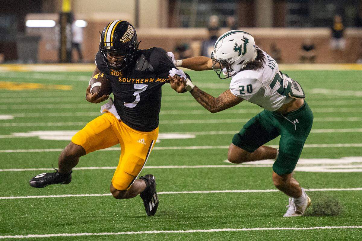 Southern Miss Golden Eagles quarterback Ethan Crawford (3) is tackled by South Florida Bulls cornerback Brent Austin (20) during a game between Southern Miss and South Florida at M.M. Roberts Stadium in Hattiesburg on Saturday, Sept. 14, 2024.
