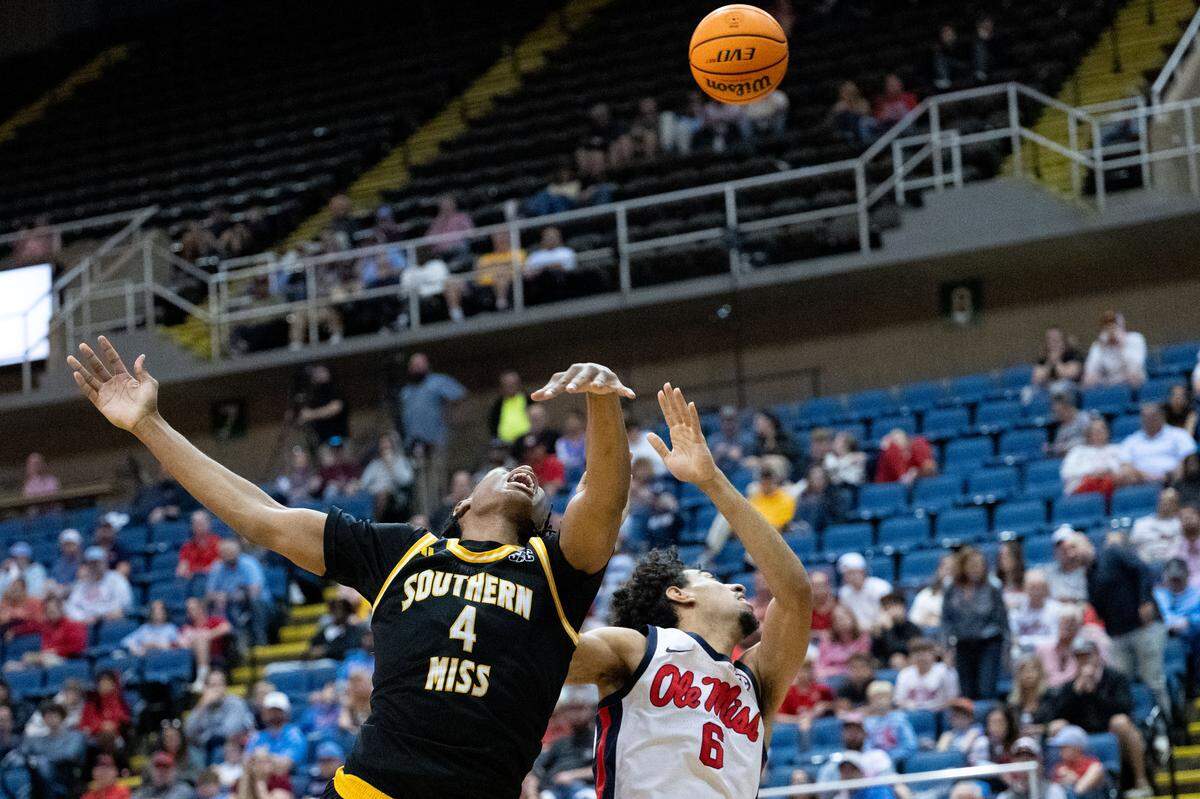 Southern Mississippi forward Tylik Weeks (4) and Mississippi guard Ilias Kamardine (6) swipe at the ball.