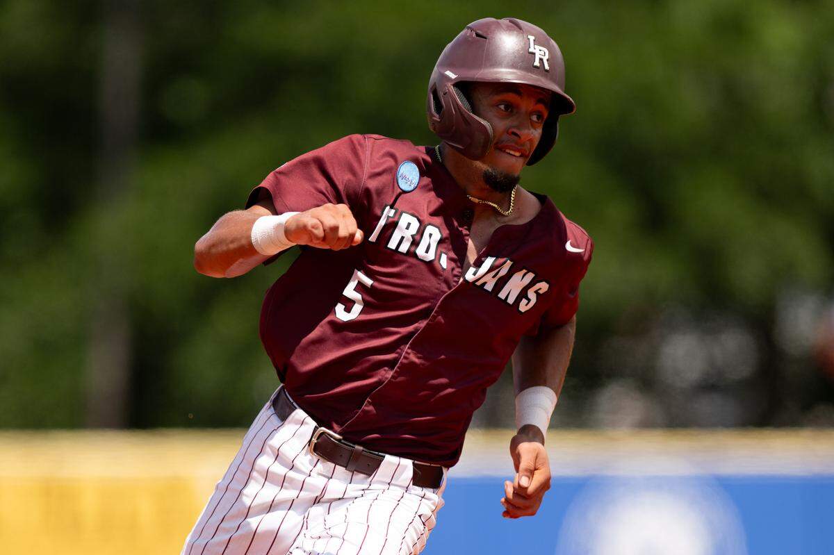 Little Rock infielder Blake Simpson (5) makes motors to third base Friday.