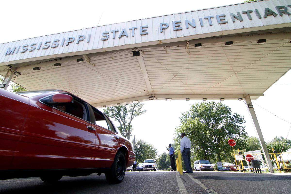Employees leave the front gate of the Mississippi State Penitentiary in Parchman. The facility handled executions for the state.