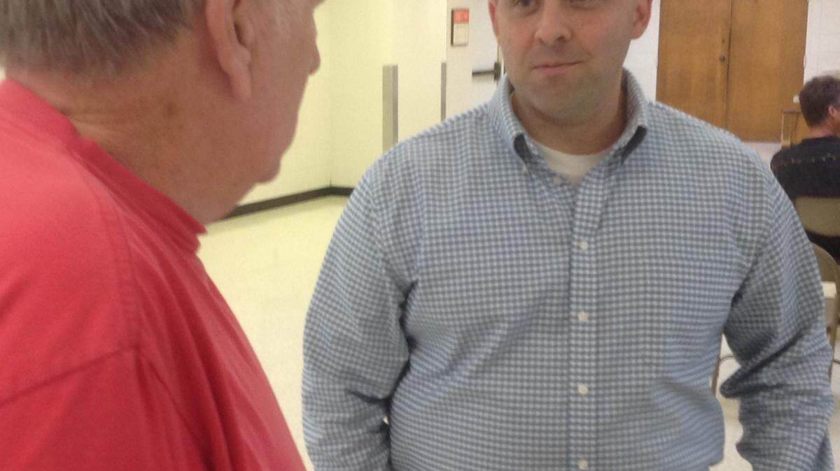 KAREN NELSON/SUN HERALD 
 Jackson County supervisor incumbent Troy Ross, right, talks with a resident before the Latimer Civic Association political forum in Latimer on Monday night.