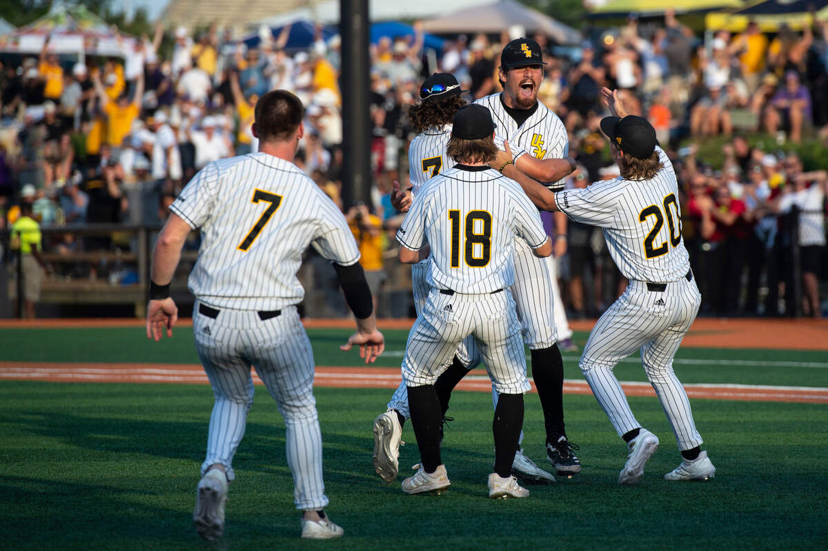 Southern Miss pitcher Tyler Stuart is embraced by his teammates as Southern Miss defeats LSU 8-7 in the NCAA Regionals at Pete Taylor Park in Hattiesburg on Monday, June 6, 2022.