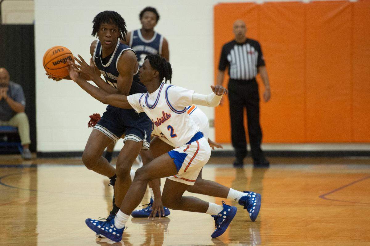 Moss Point’s Kedrick Osby keeps the ball away from Gulfport’s Zarius Gill during the Adidas Holiday Classic at Gulfport High School in Gulfport on Tuesday, Dec. 28, 2021.