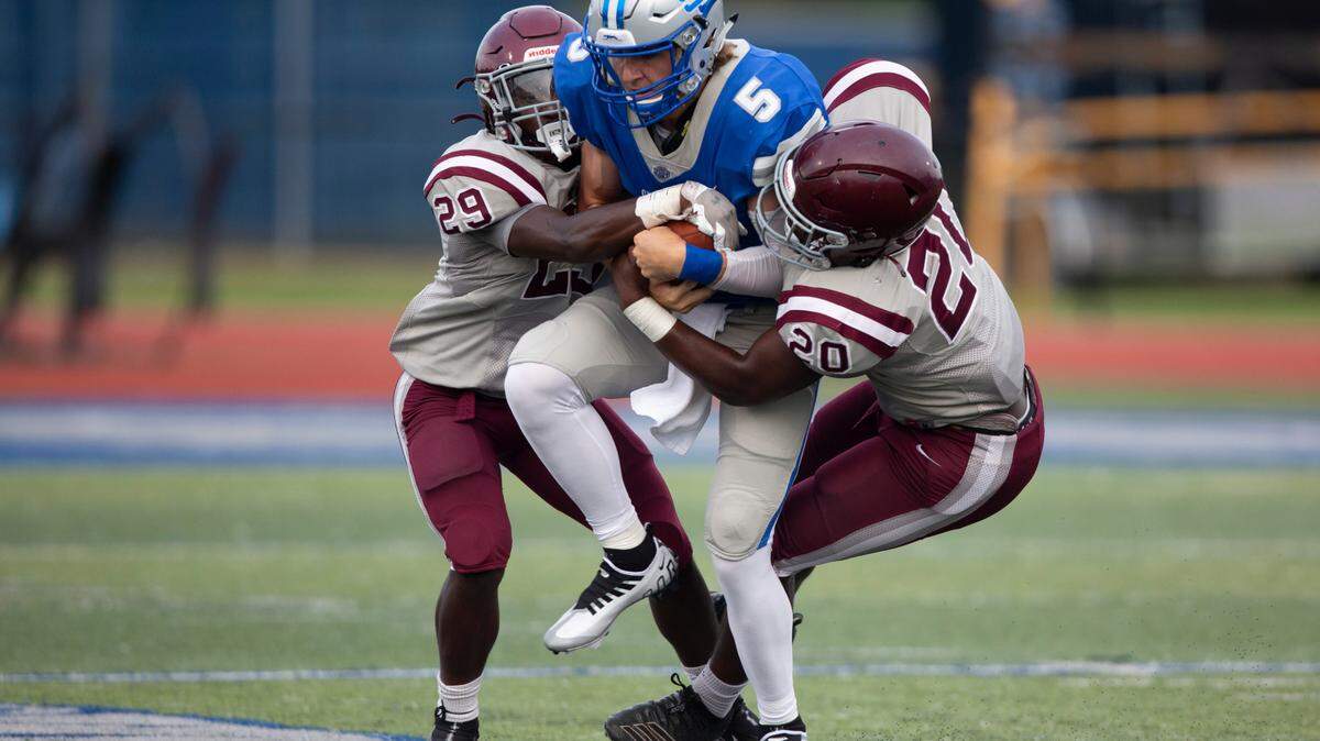 Picayune defender Amarion Tyson, left, helps sack Ocean Springs quarterback Bray Hubbard during a spring game at Greyhound Stadium in Ocean Springs on Friday, May 13, 2022.