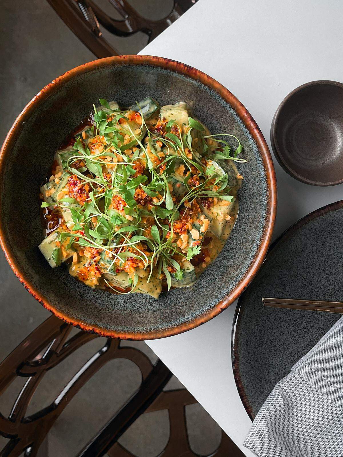 The cucumber salad with cilantro sweet chili sauce, chili crisp, roasted peanuts and micro cilantro.