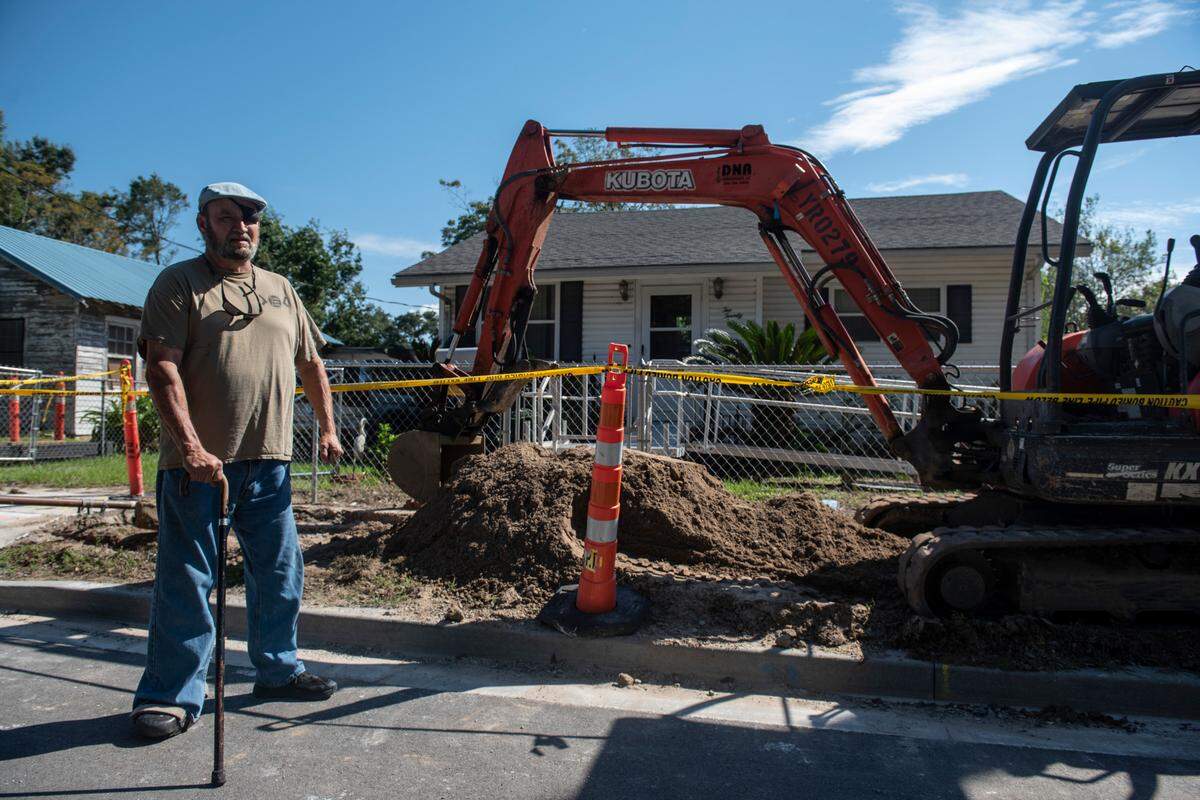 John Higgins stands outside his home where construction equipment sits in Biloxi on Friday, Oct. 1, 2021.