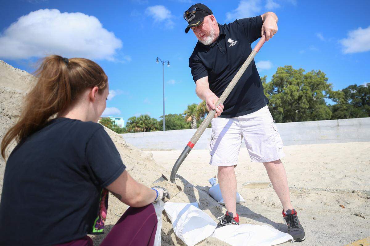 Meghan Roberts holds a sand bag as Timothy Lundy helps to it with sand. The two helped one another fill more than 15 at the Gulfport sand pile along Highway 90 to prepare for Laura as the storm makes its way towards the Mississippi Coast September 13, 2020.