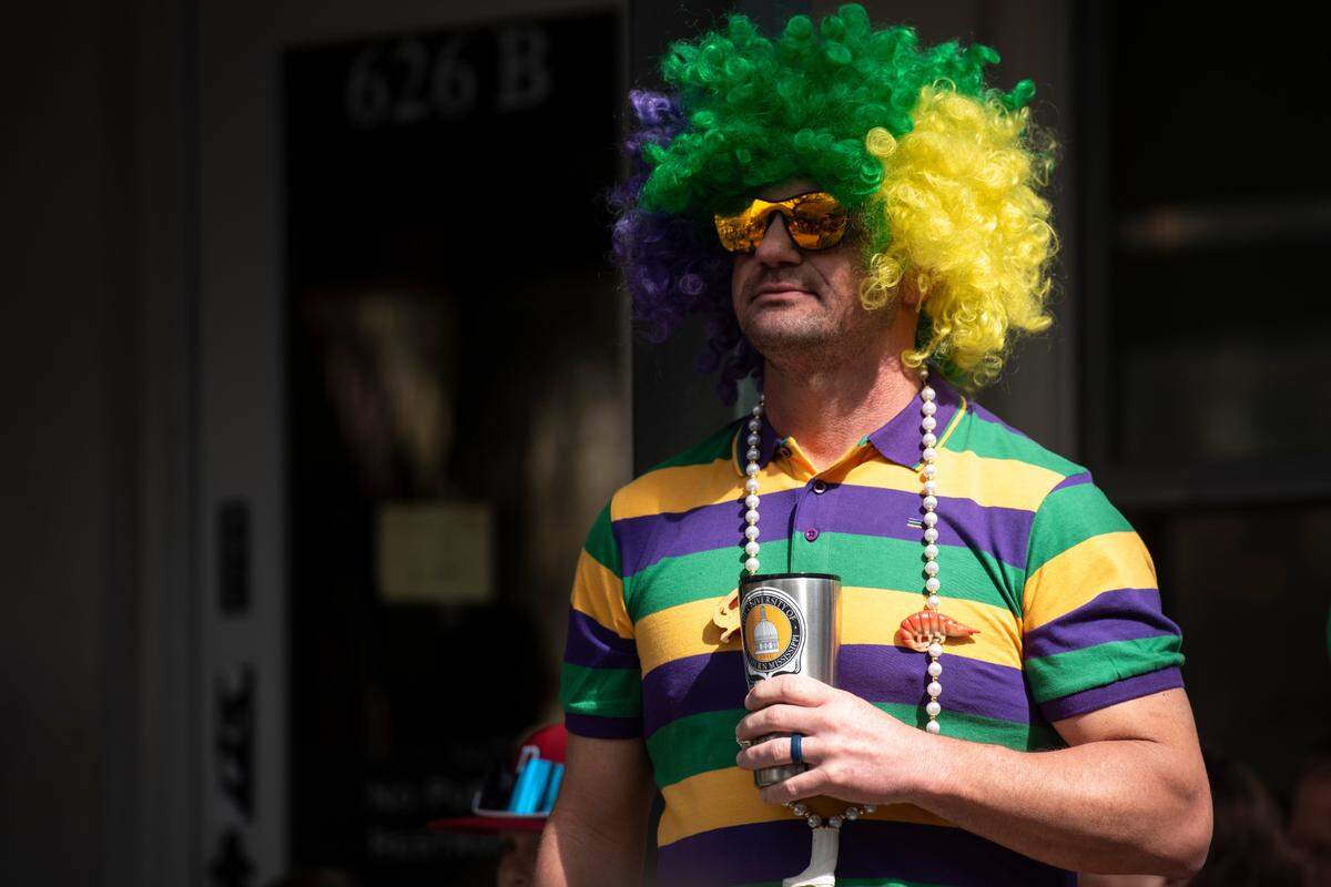 A man wears a Mardi Gras themed wig during the Ocean Springs Elks Club Mardi Gras Parade in Ocean Springs on Saturday, Feb. 15, 2025.