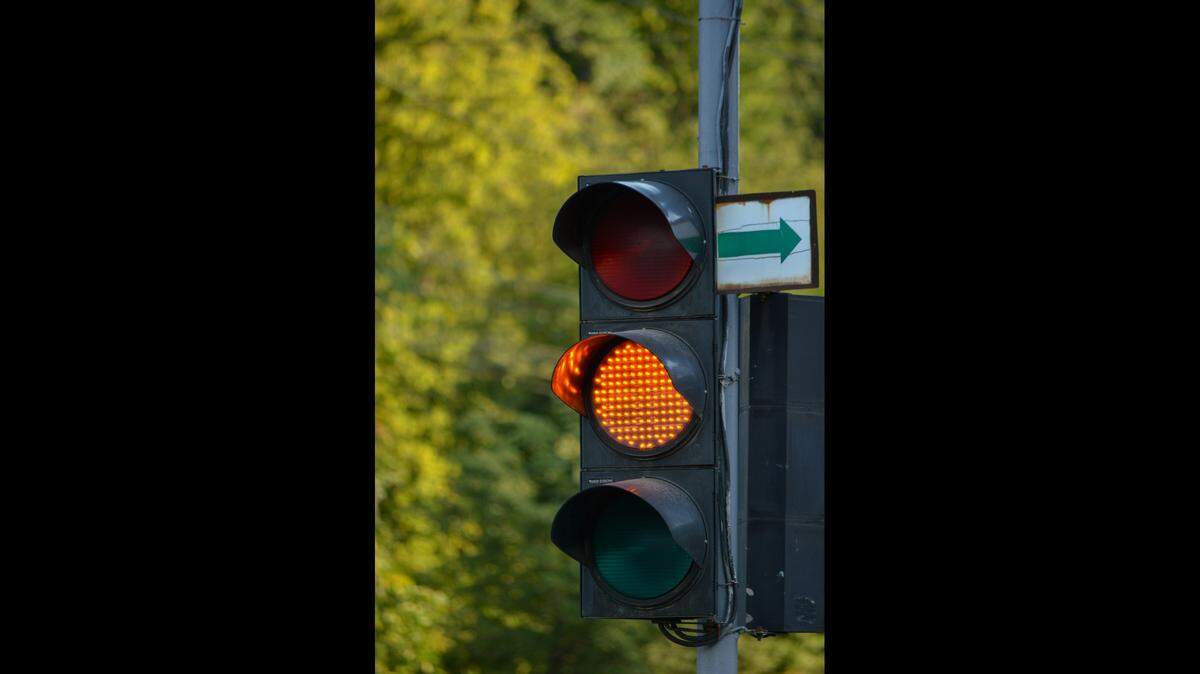A yellow traffic light can either be a signal to slow down or speed up, depending on the driver.