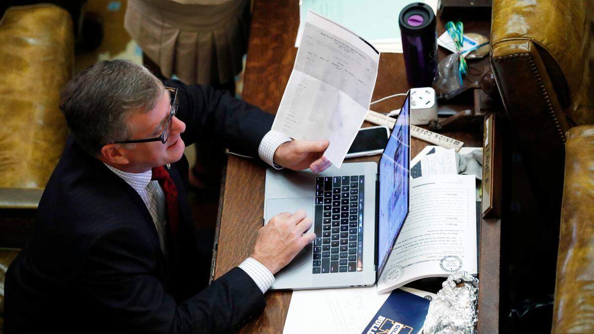 Rep. Jay Hughes, D-Oxford, reviews a print out of a vote from 2018 at the Capitol in Jackson.