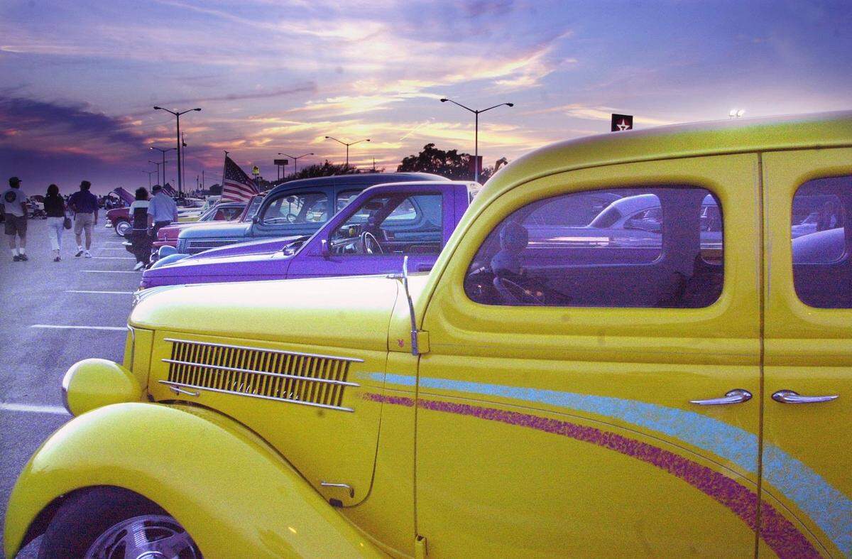 A classic yellow Ford sits under the sitting sun after a parade to kick off Cruisin The Coast in 2001. The event again is USA Today’s No. 1 car show in the country.