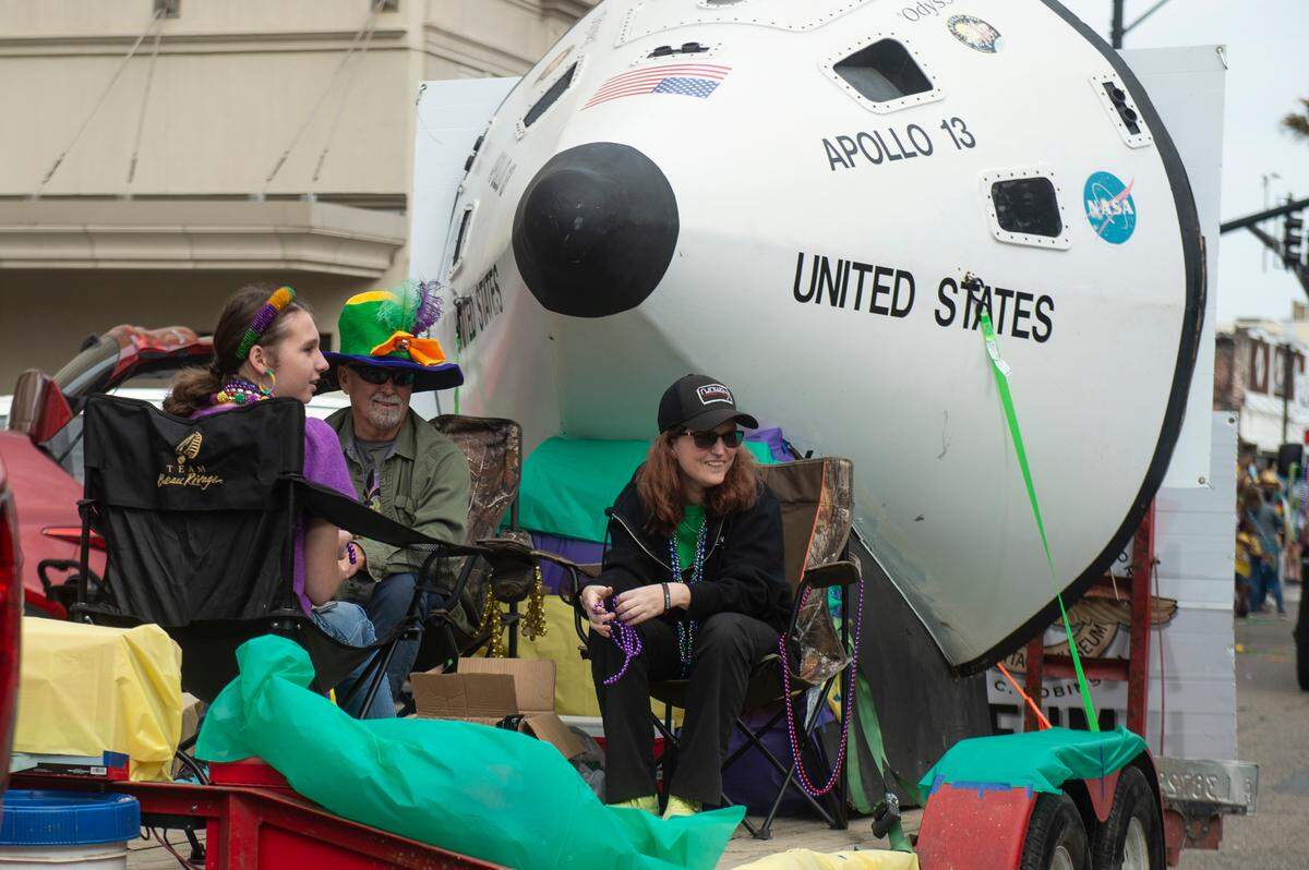 A float with a replica Apollo 13 capsule rolls through downtown Gulfport during the Krewe of Gemini parade on Saturday, Feb. 10, 2024.