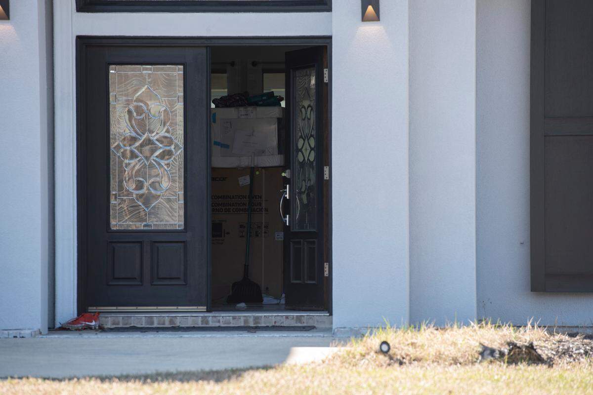 The front door of Biloxi Councilman Robert Deming’s house stands ajar as DEA agents conduct a raid on the home on Thursday, Jan. 26, 2023. Agents would not say specifically what they were looking for or what they found, but agents also conducted raids on several locations of The Candy Shop & Kratom, a kratom store chain owned by Deming.