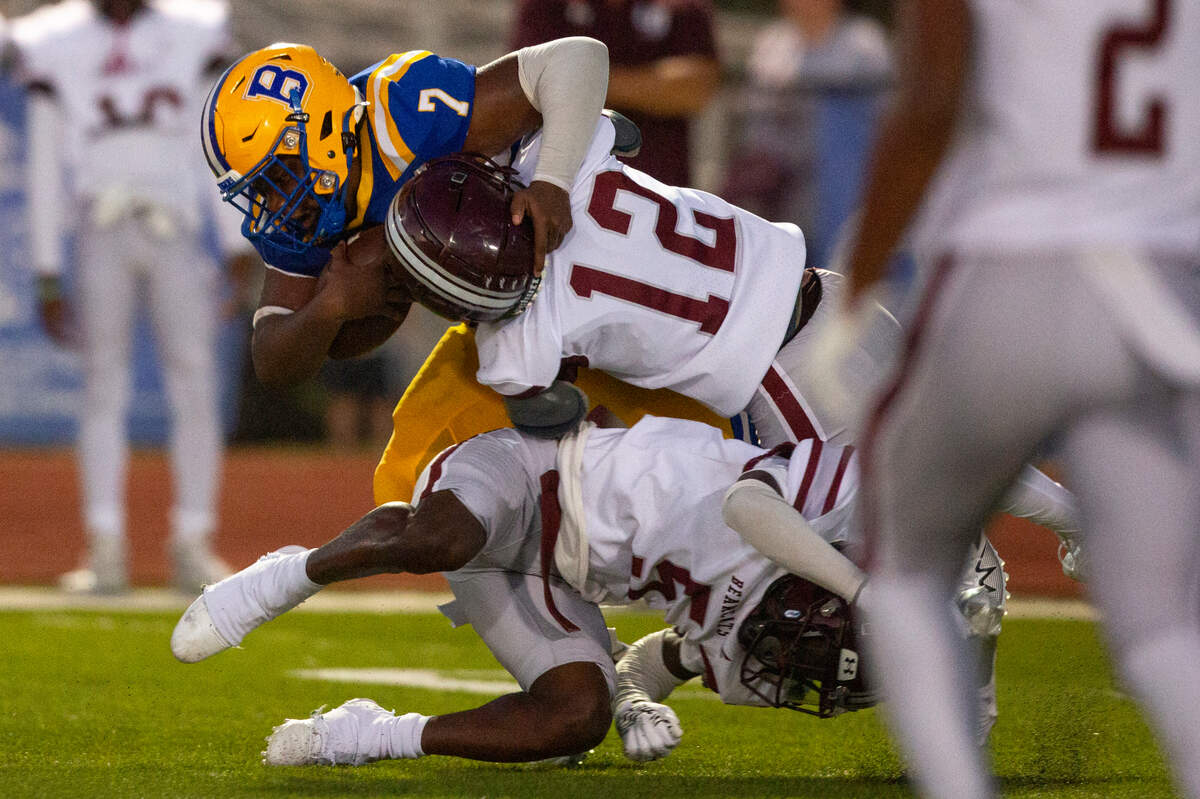 Long Beach’s Landon Thode and Rashad Foxworth tackle Bay High’s Dekaiden Johnson during a game between Bay High and Long Beach at Tiger Stadium in Bay St. Louis on Friday, Sept. 13, 2024.