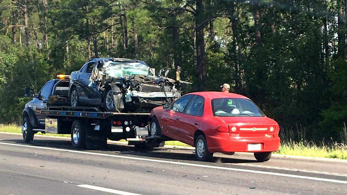 A vehicle involved in a wreck on Interstate 10 at the 55-mile marker sits on a a wrecker truck as the incident was being cleared Friday, April 13, 2018. At least one person was taken from the scene by a rescue helicopter.