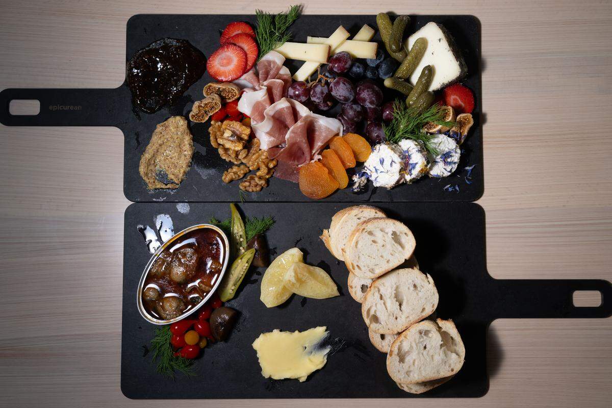 The charcuterie board, top, and the Tin of the Week, bottom, at St. James Cheese Company in Pass Christian on Friday, Sept. 5, 2025.