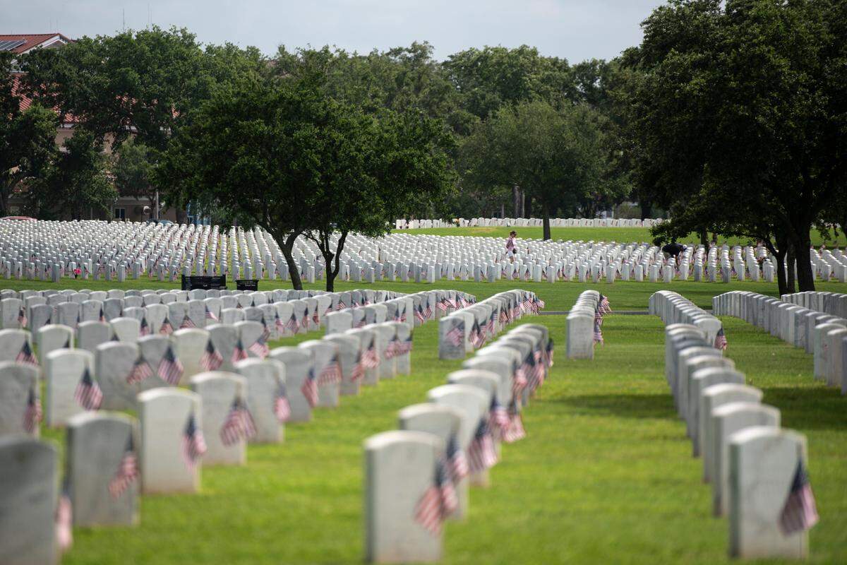 Thousands of tiny American flags decorate the graves of American service members at Biloxi National Cemetery in Biloxi ahead of Memorial Day on Saturday, May 25, 2024.
