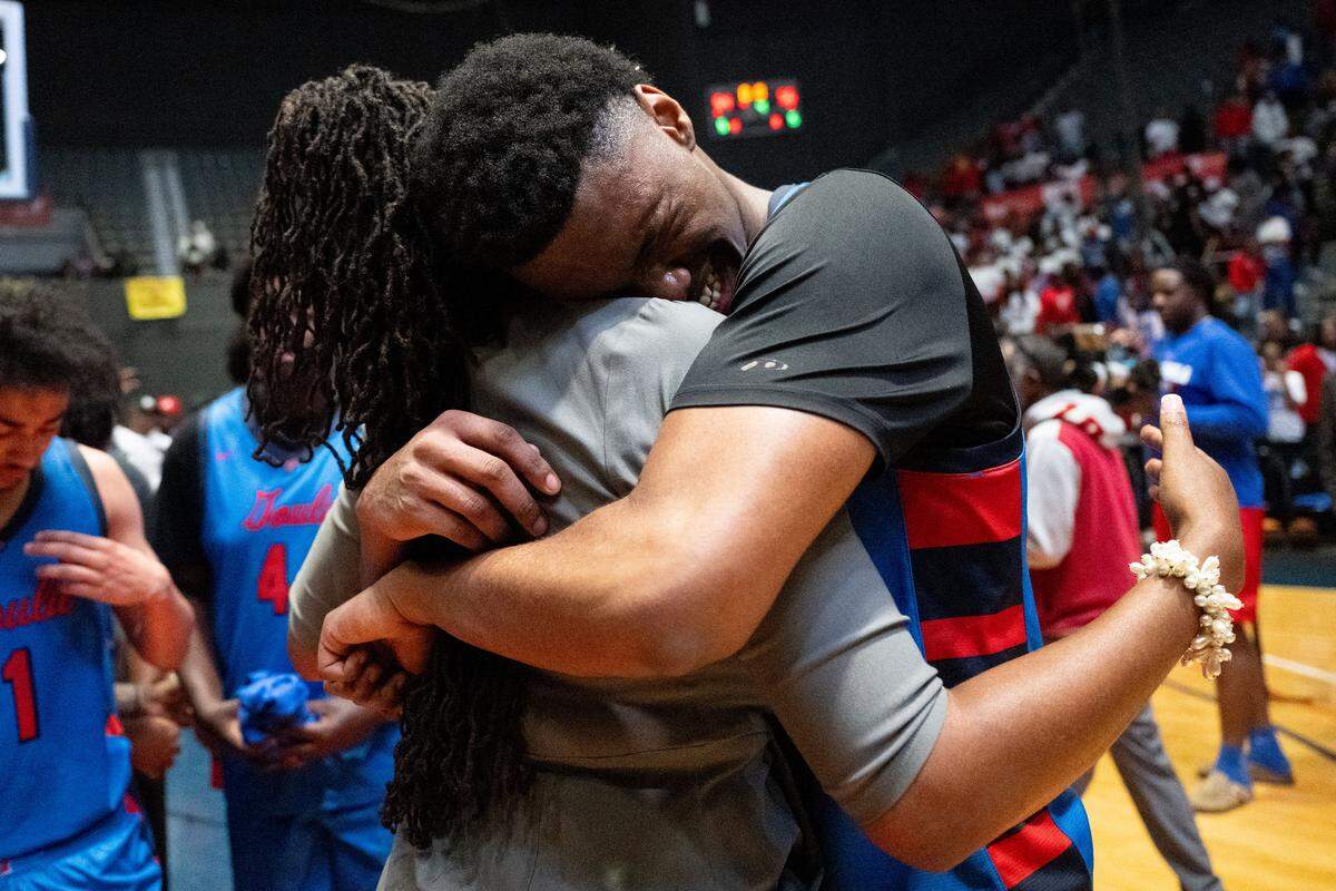Pascagoula's Tamir Boykin (21) hugs Lakia Westerfield after the Class 6A final.