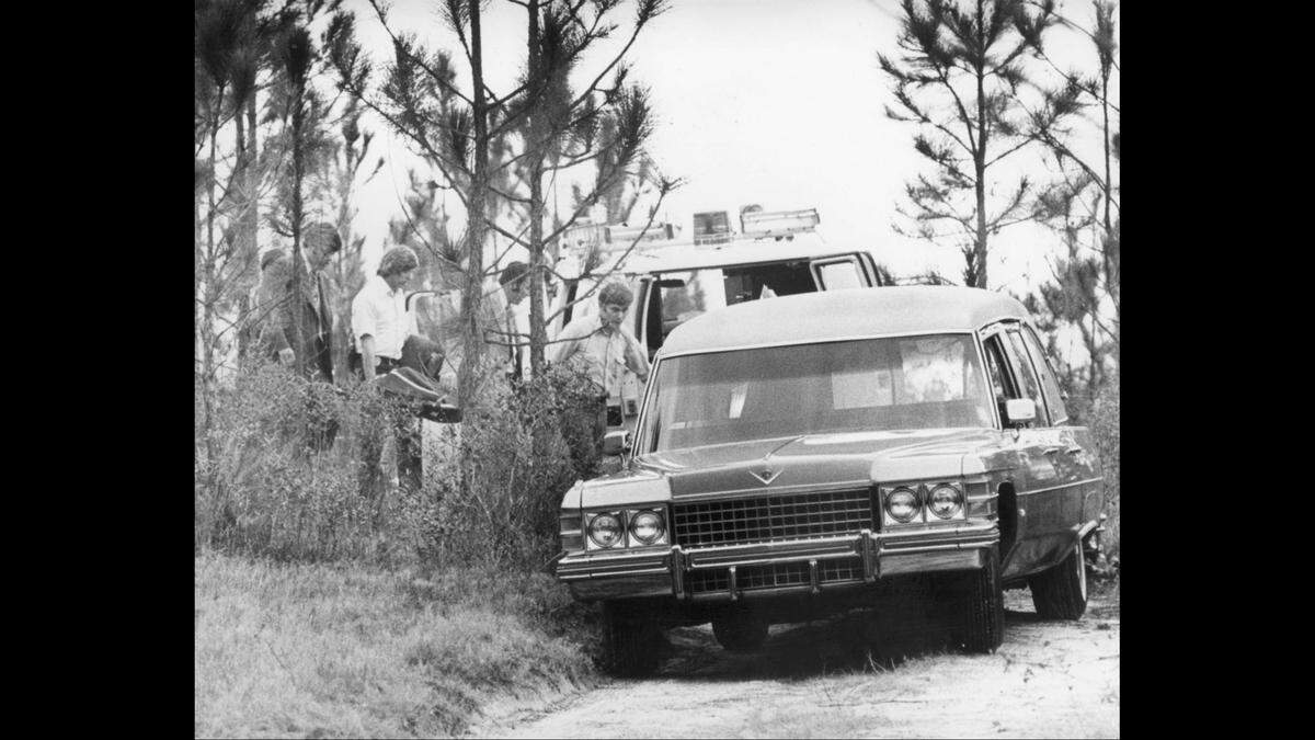 Law enforcement officers in Mississippi remove the body of Edwina Marta from a wooded area in Desoto National Forest. on the Coast. Richard Gerald Jordan was convicted of the murder and awaits execution on death row.