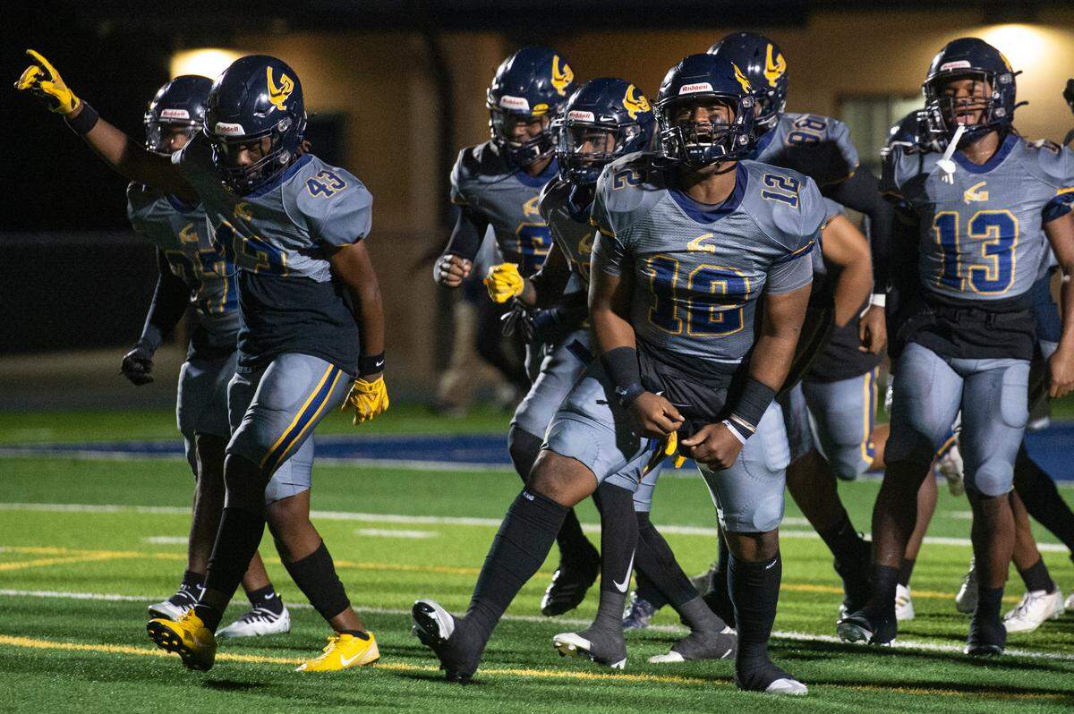 The Gautier Gators cheer as they walk out onto the field before a playoff game against Wayne County at Gautier High School in Gautier on Friday, Nov. 11, 2022.