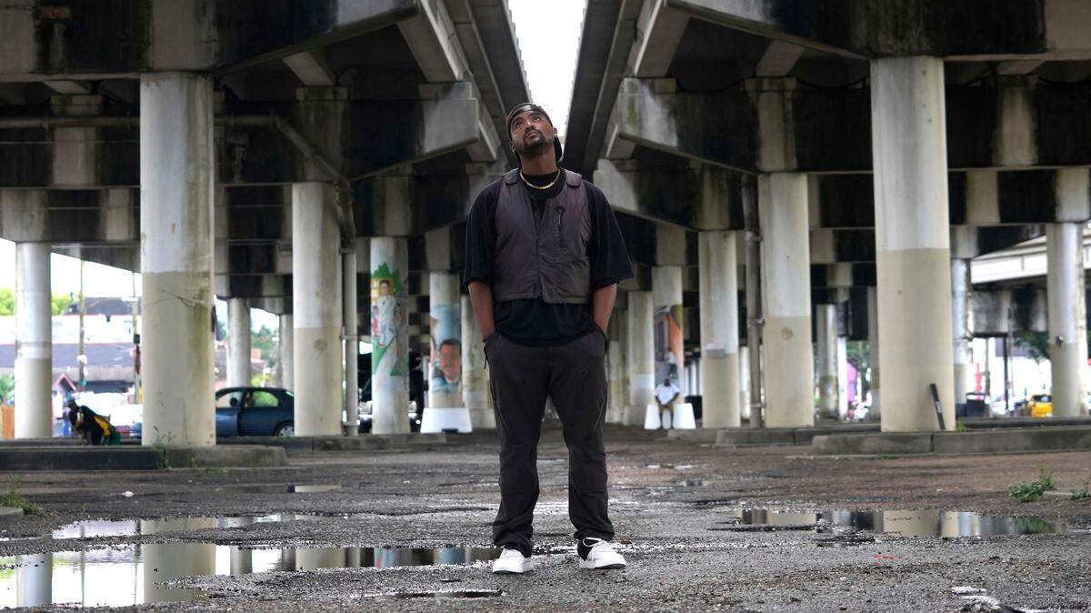 Edward Buckles, Jr., a New Orleans native who was 13 when Hurricane Katrina hit and directed the documentary “Katrina Babies,” poses underneath the Claiborne Avenue overpass for a photo in the city on Friday, Aug. 19, 2022. The film looks at how a generation of New Orleans residents coming of age after Hurricane Katrina, are reconciling with the catastrophic storm that transformed their lives. (AP Photo/Chansey Augustine)