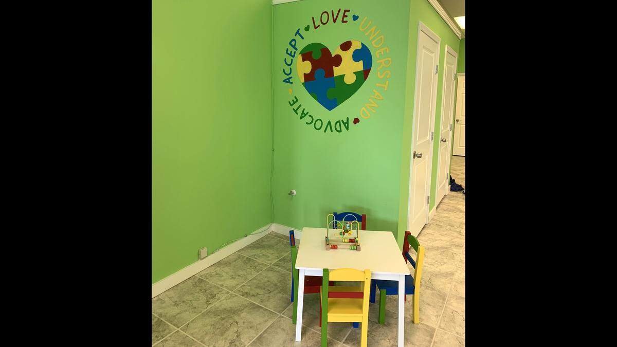 A kids’ table and an autism logo are part of the welcome at the new Ashley’s Juice & Salad Bar in D’Iberville.