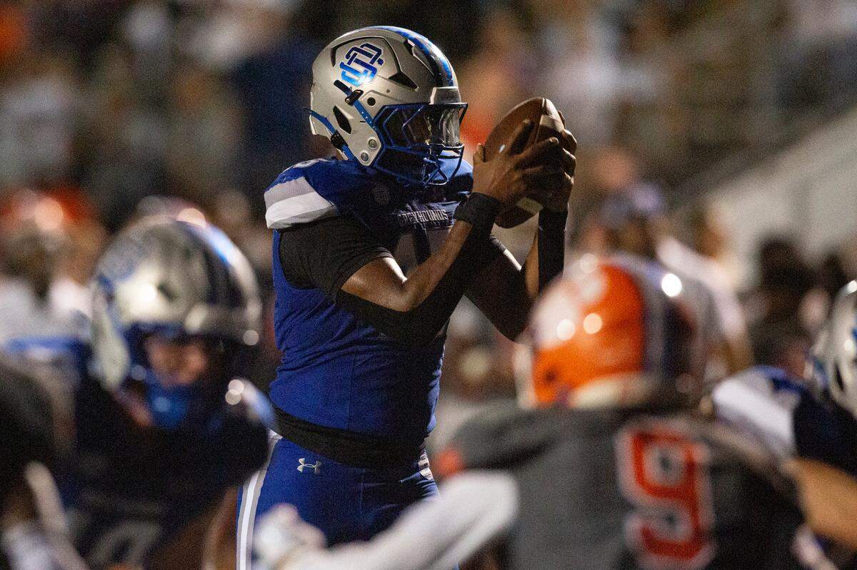 Ocean Springs’ BJ Ausmer prepares to run the ball into the end zone for a touchdown during a game against Madison Central at Greyhound Stadium in Ocean Springs on Friday, Aug. 30, 2024.