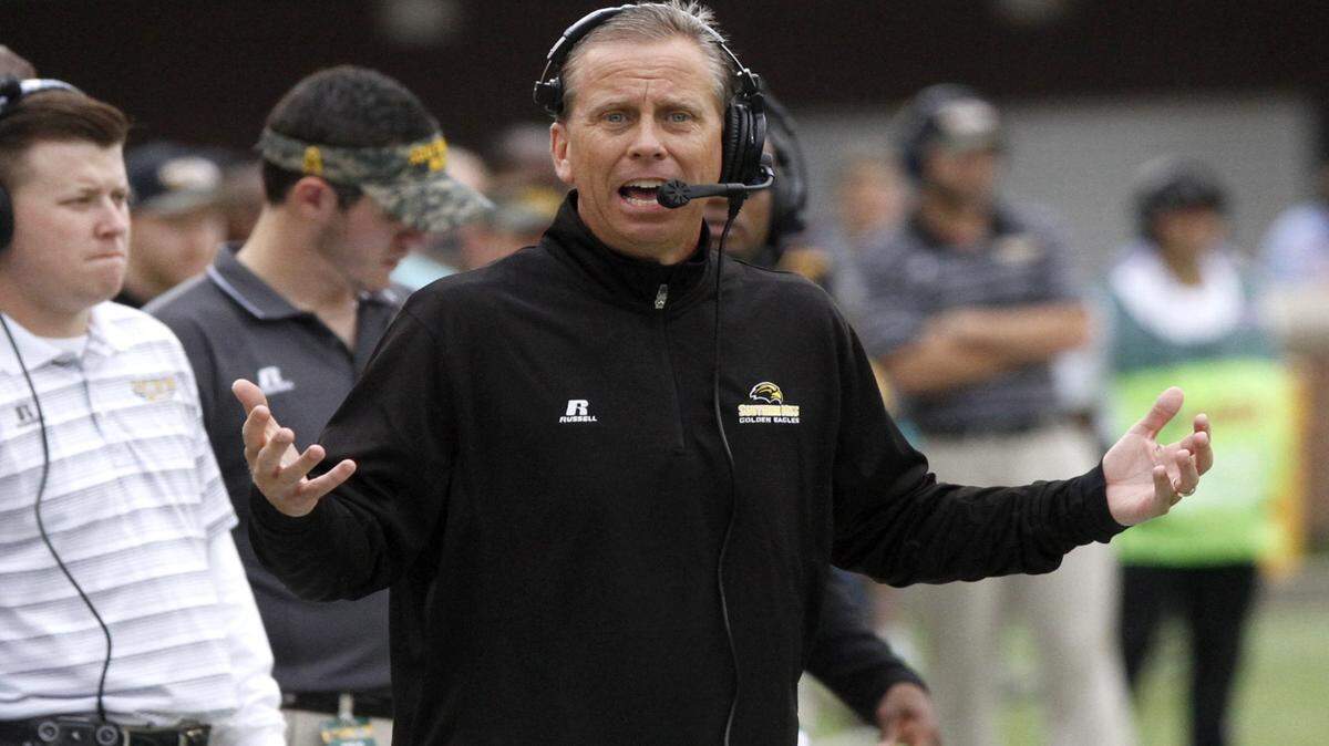 TIM ISBELL/SUN HERALD 
 Southern Miss coach Todd Monken pleads his case with the referee during game against Old Dominion.