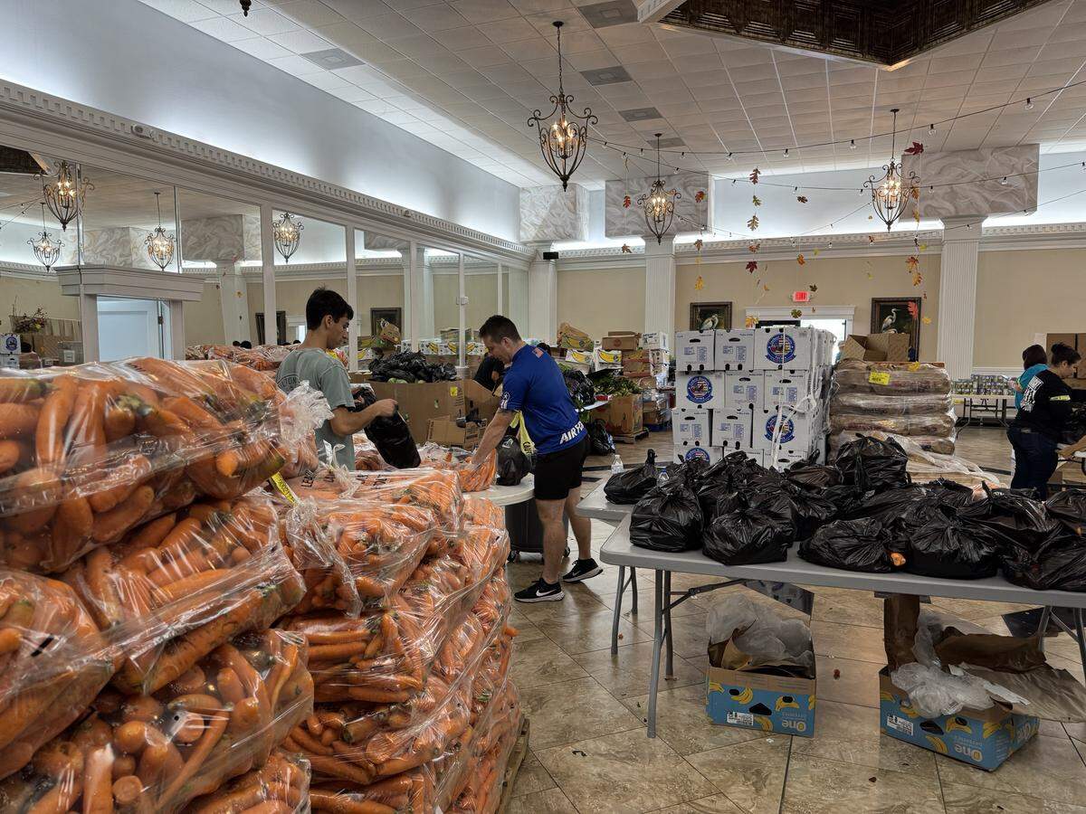 Volunteers at Hope for the Coast food pantry in Biloxi sort items for a food giveaway organized to help employees of Keesler Air Force Base in Biloxi who are going without pay during the government shutdown, including civil service workers. 