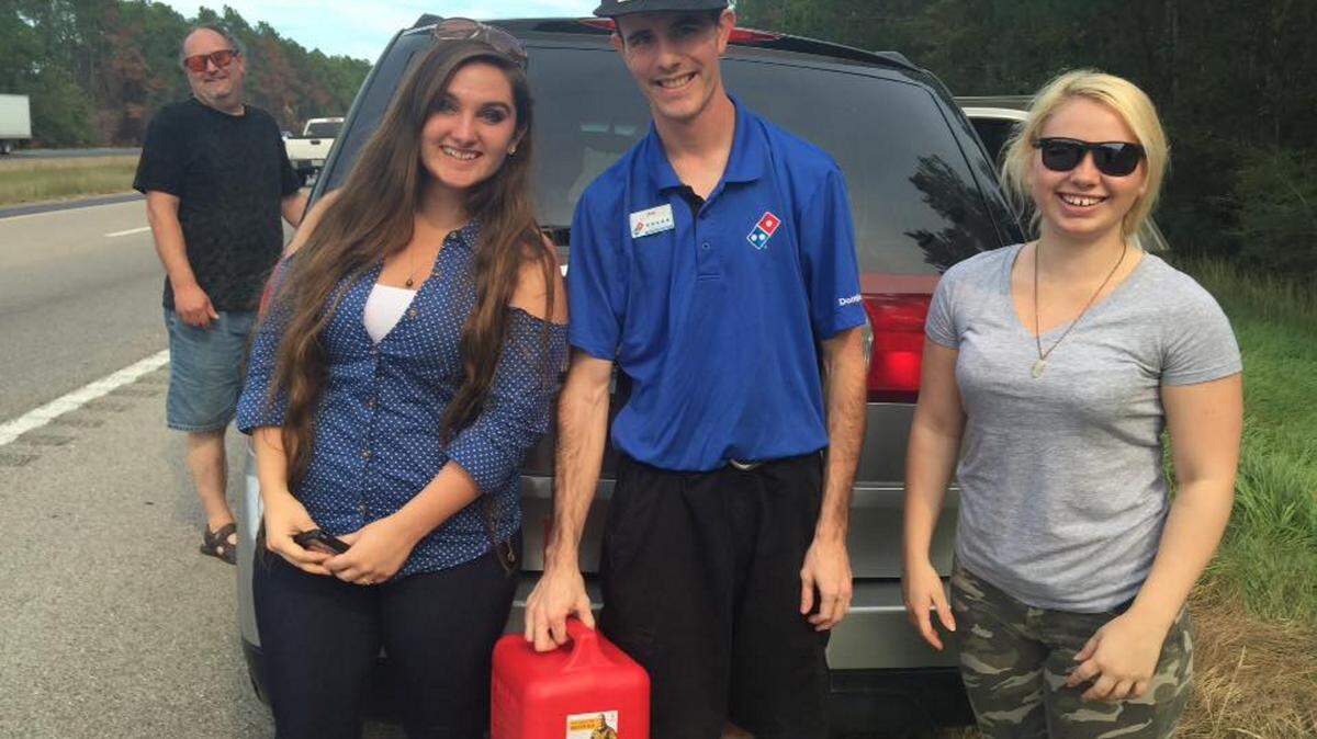 COURTESY KATRINA KINDERKatrina Kinder, left, and her sister Isabella Kinder pause for a quick photo with Diamondhead Domino's Pizza driver Bob Davis on Oct. 8. Davis brought them gas after they ran out on Interstate 10 near Stennis Space Center en route to Biloxi for a vacation.