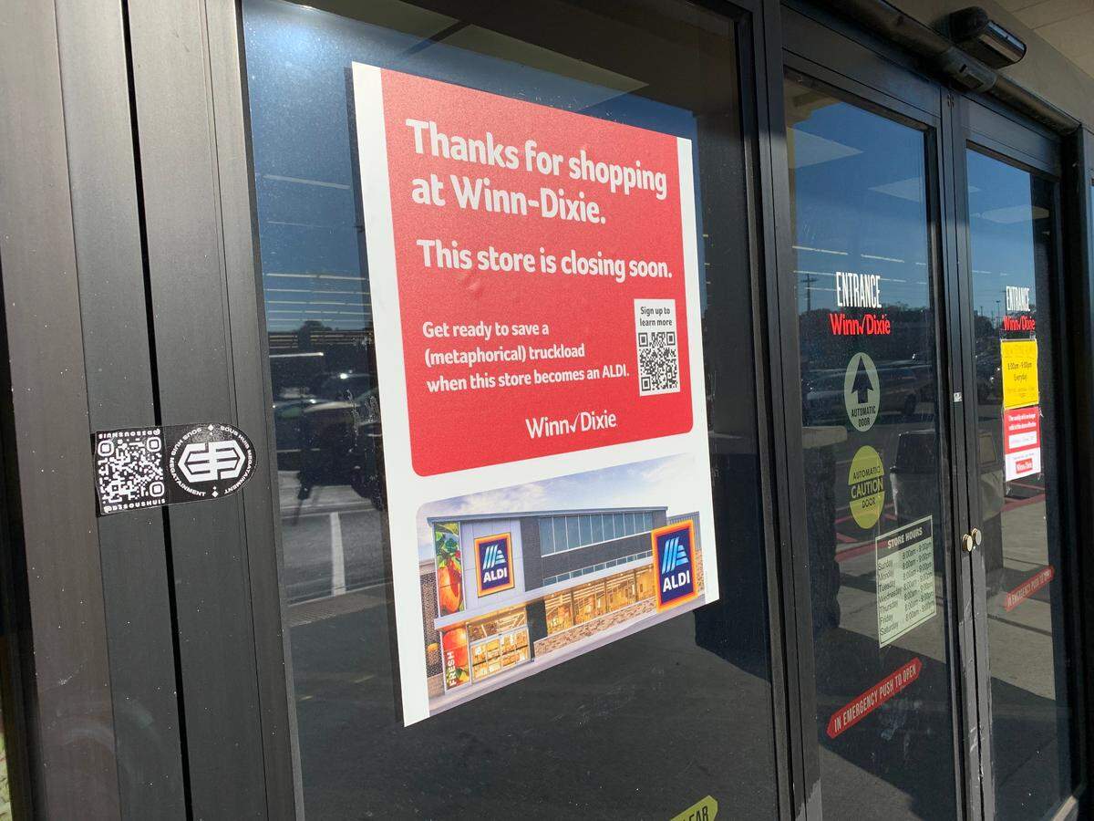 A sign on the Orange Grove Winn-Dixie store alerts customers to the changes coming. A closing sale is in progress.