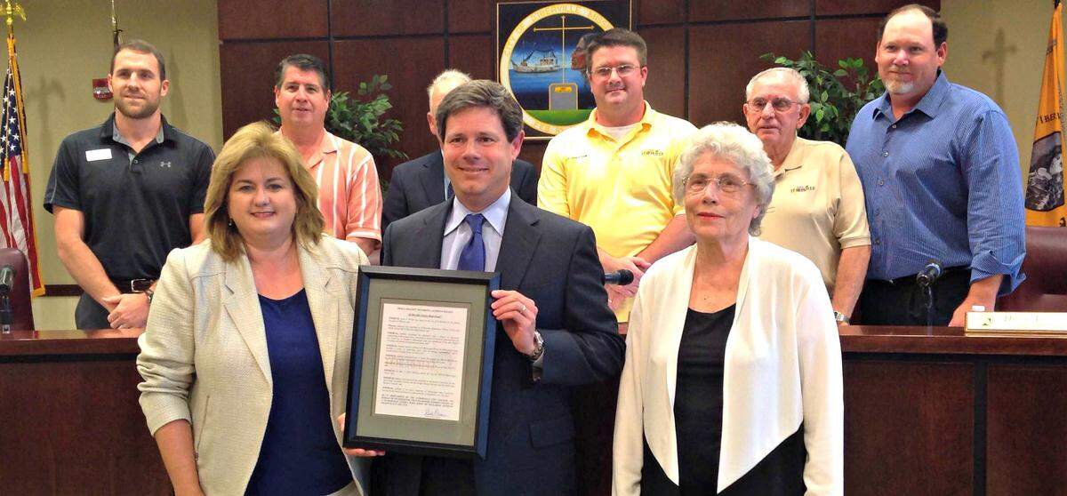 Anthony Wilson, president and CEO of Mississippi Power, holds his award for D’Iberville Citizen Made Good that was presented Tuesday. City officials stand behind Wilson, his wife Tonya, left, and his mother, Joy Wilson, right, in this 2016 file photo.