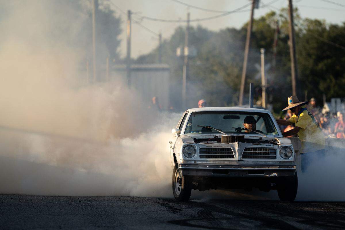 A car kicks up smoke during Burn ‘Em Up In The Pass on Thursday, Oct. 9, 2025.