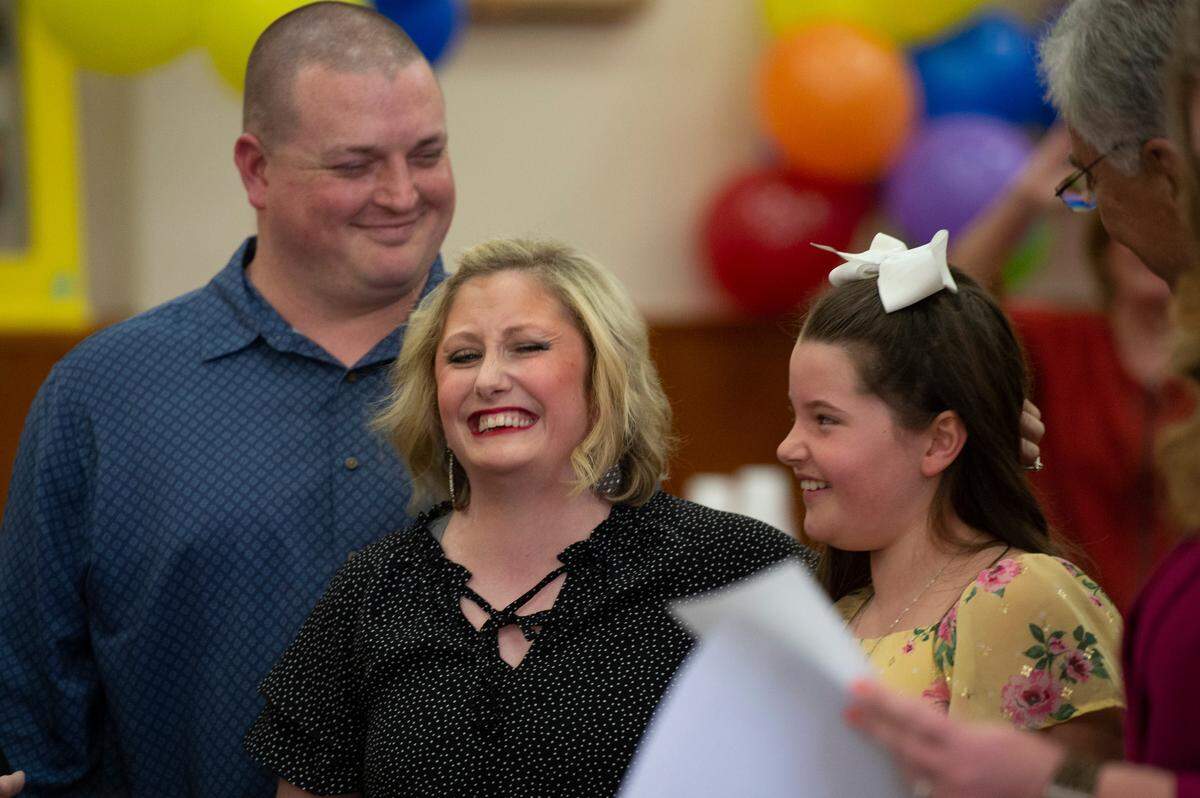 Brittany Mast, center, reacts as the adoption of her daughter Kyleigh, 9, right is finalized during adoption day at Jackson County Court in Pascagoula on Thursday, March 10, 2022.