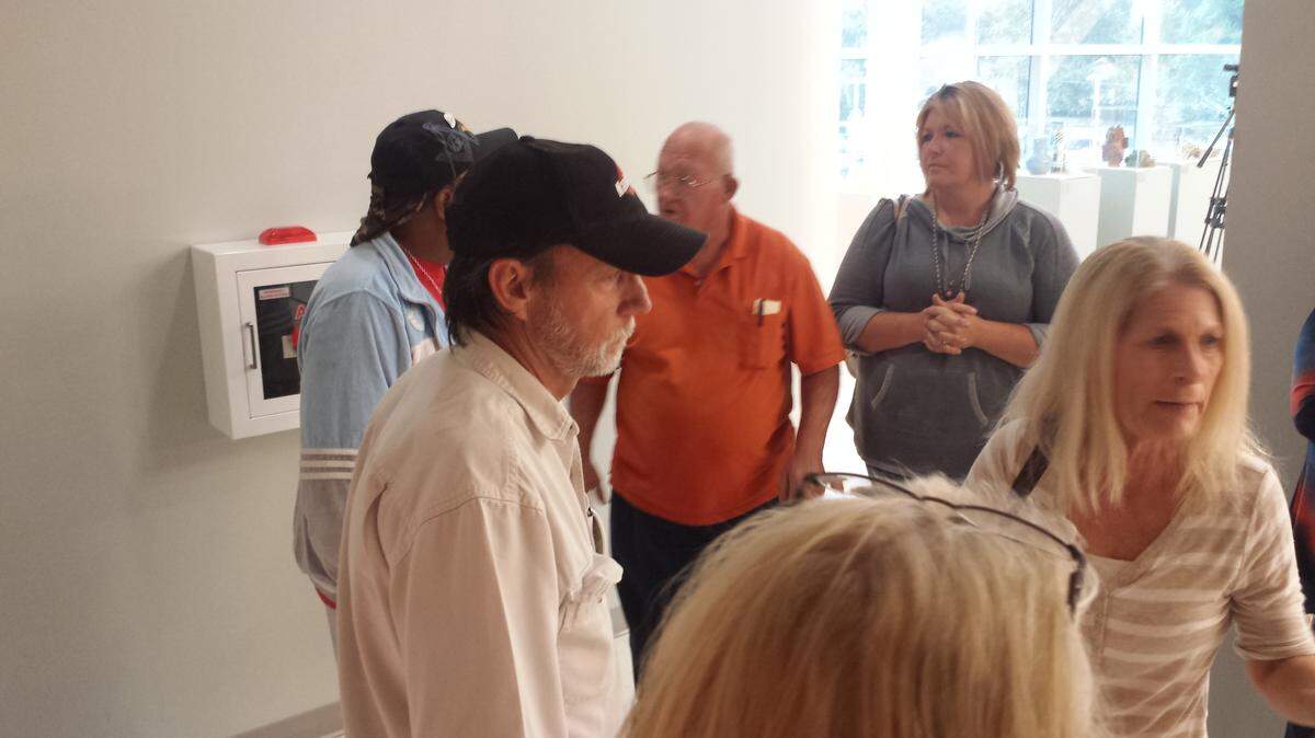 KAREN NELSON/SUN HERALD 
 Irby Tillman, center, outside the Jackson County Board of Supervisors meeting. He said told supervisors not to limit boats, "This is America."