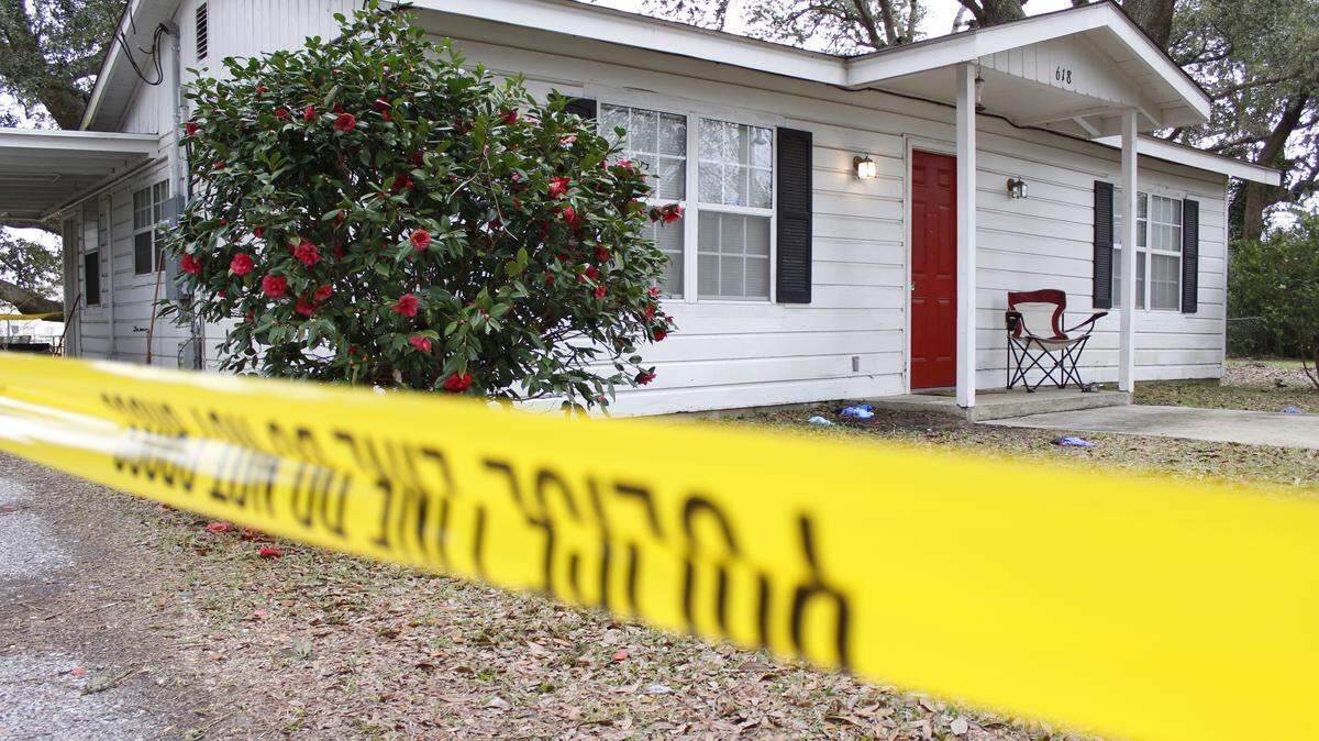 WESLEY MULLER/SUN HERALD 
 Crime-scene tape remains around the house of Karen Humphries in the usually quiet neighborhood near St. Joseph Street and Jeff Davis Avenue on Friday, Jan. 22, 2015. Waveland police said Humphries was found dead under suspicious circumstances in her home Thursday.