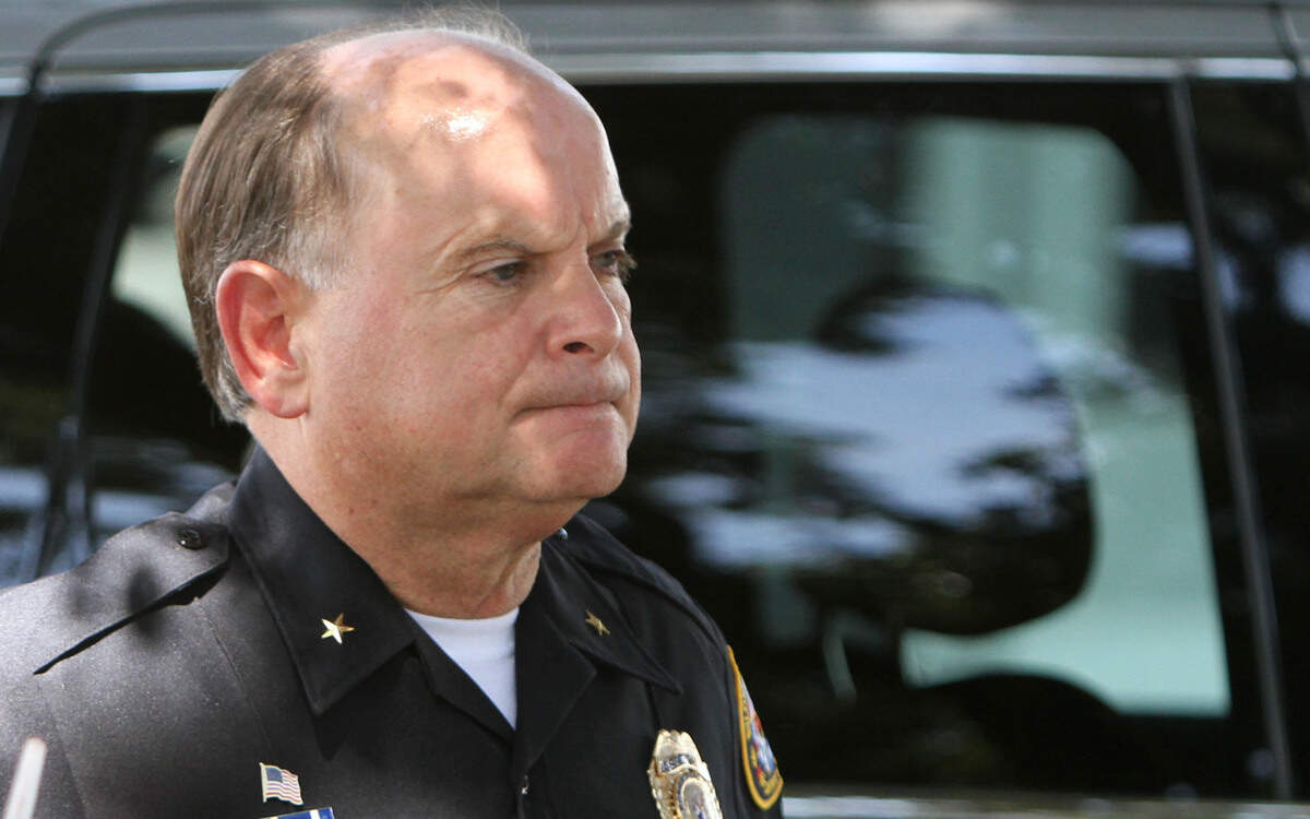 JOHN FITZHUGH/SUN HERALDAssistant Biloxi Police  Chief Rodney McGilvary watches as investigators work the scene of a homicide in the parking lot of Iron Works Gym on Eisenhower Road on Wednesday July 15, 2015.