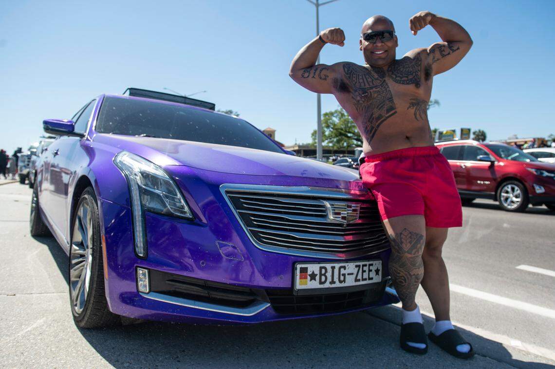 Zemarion “Big Zee” Meeks, of Charleston, Mississippi, poses with his purple Cadillac during Black Spring Break in Biloxi on Saturday, April 9, 2022.
