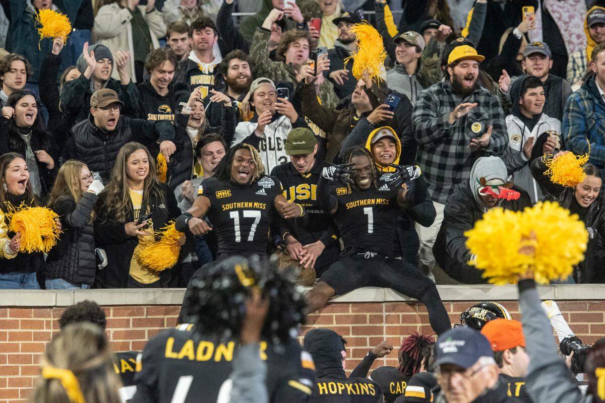 Southern Miss players celebrate with fans after winning the Lending Tree Bowl at Hancock Whitney Stadium in Mobile, Alabama on Saturday, Dec. 17, 2022.