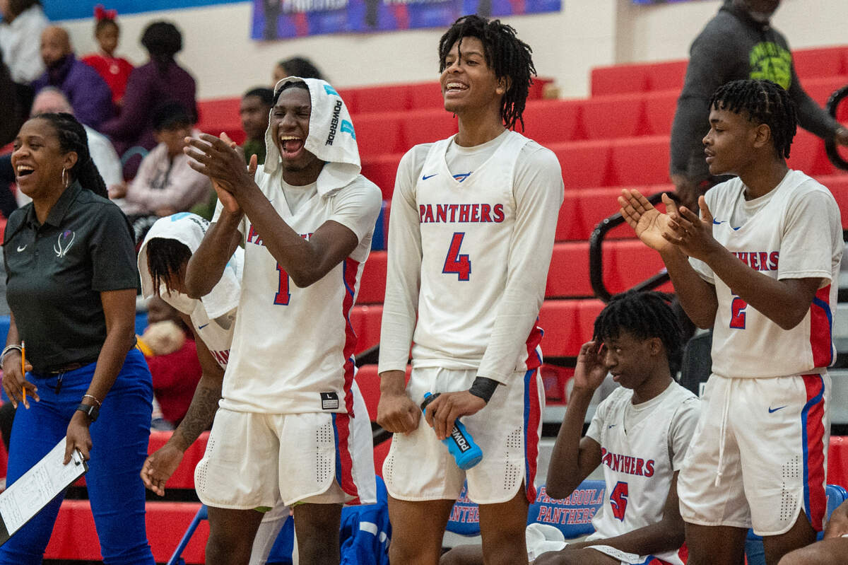 Pascagoula’s Pete Millender and Dorrian McMillian cheer on their teammates during a game against Pass Christian at Pascagoula High School on Tuesday, Dec. 20, 2022.