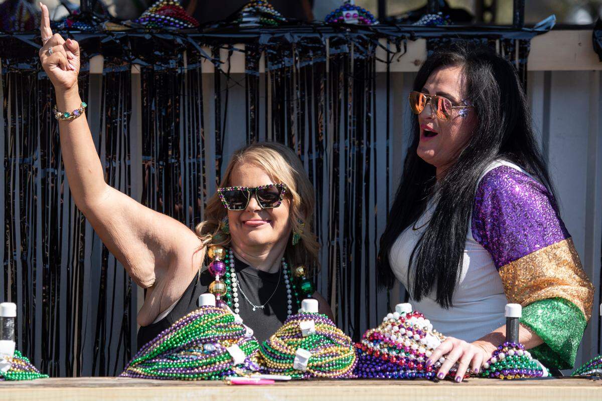 Krewes toss beads and other throws during the Jackson County Carnival Association Mardi Gras parade in Pascagoula on Saturday, March 1, 2025.
