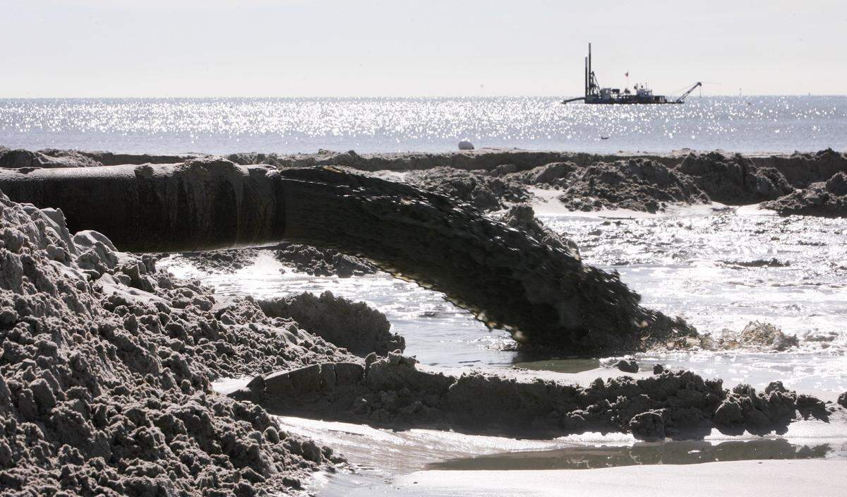 An offshore dredge pumped about 1,000 gallons of sand and water a minute onto the beach in Harrison County during a sand replenishment project in 2008.